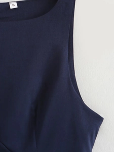 Detailed view of the round neckline and stitching on this navy blue sleeveless dress