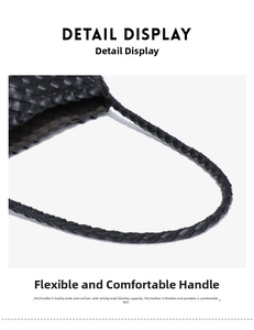 Detail showing the flexible woven leather handle and the texture of the black bucket bag