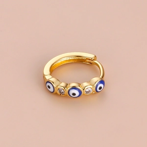 Golden hoop earring with blue and white enamel evil eye motifs and sparkling zircon stones