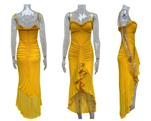 Detail of yellow bodycon dress showing ruffle trim, thin straps and asymmetrical hemline
