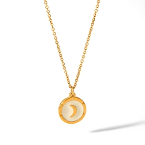 Macro shot of gold crescent moon on milky white inlay with a polished steel chain
