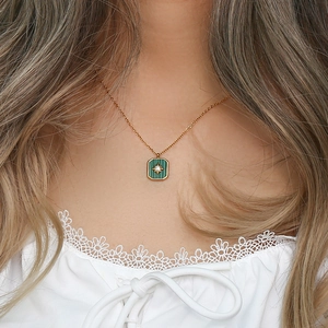 Vintage green square pendant necklace with starburst rhinestone shown on a model