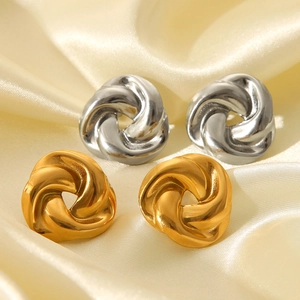 Twisted knot stud earrings in 18K gold and silver finishes on elegant satin fabric