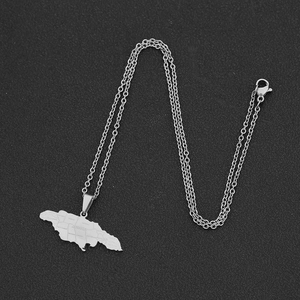 Detailed close-up of a silver stainless steel Jamaica map pendant with engraved letters