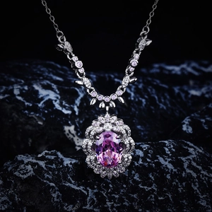 Detailed macro view of the pink oval gemstone necklace with silver diamond-set frame