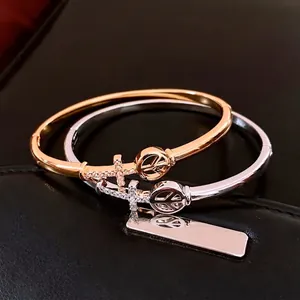 18K gold plated arrow cross bangle set with peace symbol and shimmering crystals