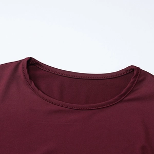 Close-up of crew neckline on burgundy long sleeve dress with premium double stitching