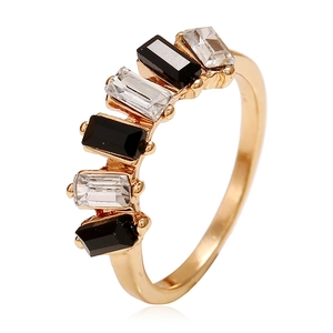 Gold ring with alternating black and white rectangular crystals in a geometric design