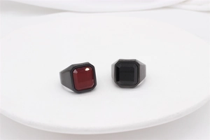 Top view of square red and black gemstones on heavy stainless steel rings for men