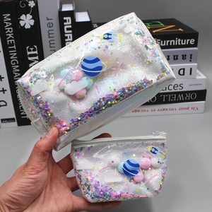 Close-up of laser holographic makeup bag set with planet, pompom and sequin details