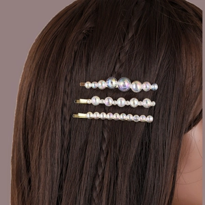 Set of three colorful iridescent pearl hair clips on model with brown hair