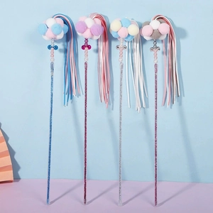 Detailed view of cat teaser sticks with macaron plush balls and sparkling glitter handles
