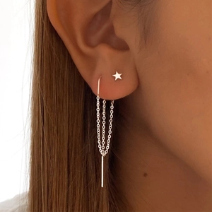 Close-up of S925 sterling silver star stud and double chain tassel earrings on ear