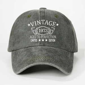 Detail of vintage 1973 printed text on washed cotton baseball cap with retro distressed look