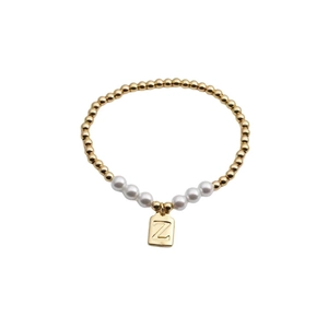 Gold beaded and white pearl stretch bracelet featuring a square pendant with letter Z