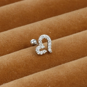 Macro view of silver stainless steel heart cartilage stud with micro-pave zircons
