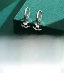 Detail of S925 silver rocking horse earrings with handset cubic zirconia micro-inlay