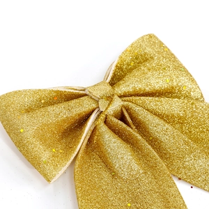 Sparkling gold glitter Christmas bow ornament for elegant holiday tree decoration