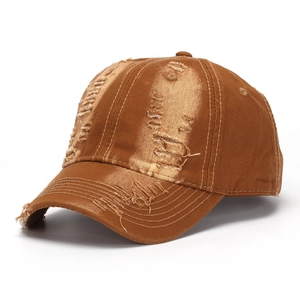 Detailed macro shot of vintage distressed baseball cap with ripped fabric and frayed holes