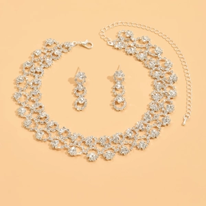 Detailed view of silver bridal jewelry set with multi-row rhinestone necklace and earrings