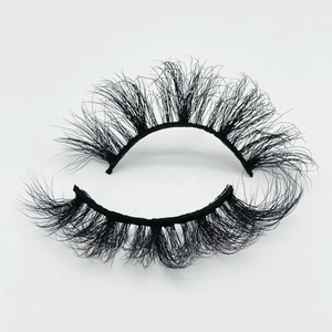 Macro detail of 20mm thick mink faux eyelashes with dramatic curl on white background