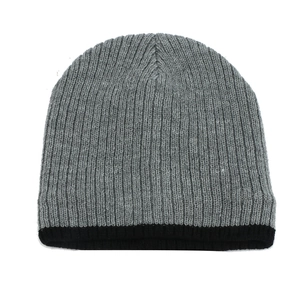 Macro detail of gray knitted beanie showing vertical rib textures and black cuff trim