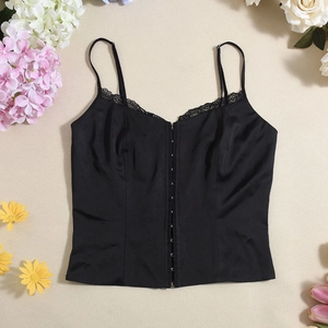 Detailed view of black satin corset camisole with lace trim and hook-and-eye closure
