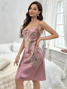 Detailed view of pink floral satin sleepwear with delicate straps and a cowl neckline