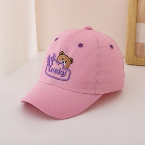 Close-up of pink cotton baseball cap with embroidered brown bear and Lucky lettering