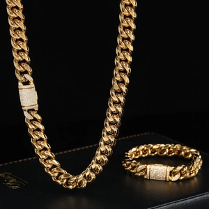 Macro shot of 12mm gold plated Cuban link chain with luxury iced out clasp detail