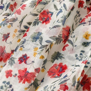 Close-up of red floral voile scarf showing breathable cotton linen weave texture