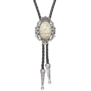Detailed view of crown bolo tie with white turquoise stone and silver tips