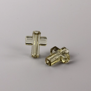 Macro shot of two transparent amber crystal cross beads for DIY jewelry making