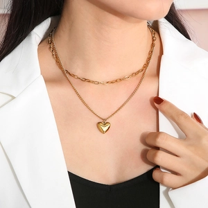 Double-layered gold necklace with heart pendant and oval link chain for women