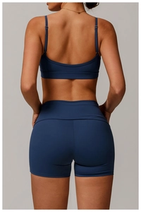 Detail of cross-back straps and moisture-wicking fabric on navy blue sports bra
