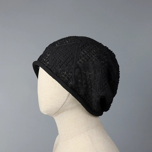 Side view of a black Japanese-style hollow-out knit slouchy beanie on a mannequin head