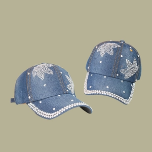 Blue denim baseball cap with silver rhinestone leaf design and curved brim