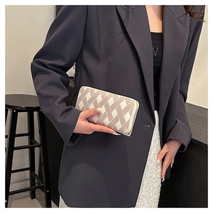 Detail of hand-held beige woven long wallet with cross pattern for professional look