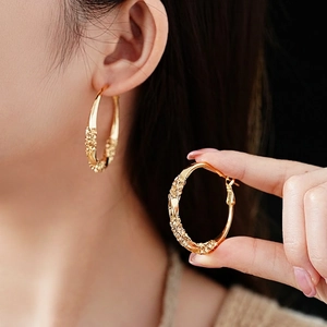 Luxury twisted gold hoop earrings with sparkling pave crystals for women in fashion style