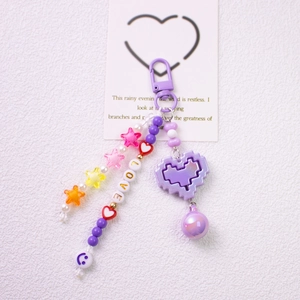 Detail view of purple LOVE beaded keychain with star, heart, and pixel heart charms