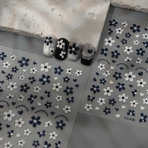3D flower and pearl nail art stickers set with black and white heart designs on grey background