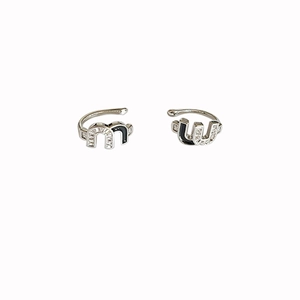 Minimalist silver 'M' and 'U' letter ear cuffs with zircon and black enamel finish