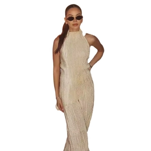 Women's pleated champagne gold two-piece set featuring long pants and casual top