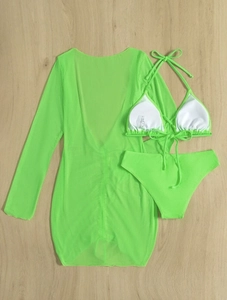 Detail of neon green 3-piece bikini set with long sheer mesh cover-up on wood background