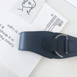 Detail of navy blue wide corset belt with large silver D-buckle and premium leather texture