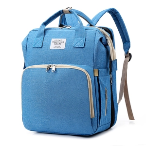 Detail view of large capacity diaper bag showing durable navy blue canvas fabric and zippers