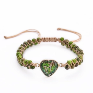 Detailed macro shot of a heart-shaped turquoise stone on a hand-woven bohemian bracelet