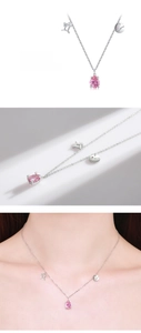 Detail of S925 silver Gemini necklace with a pink pear-cut gem and zodiac charms