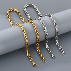 Detailed view of gold and silver stainless steel link chains with lobster clasps