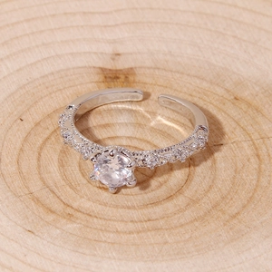 Elegant silver open ring with round clear gemstone and intricate filigree detailing